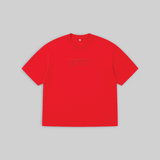 A bright red short-sleeve crewneck t-shirt with a subtle tonal dark red graphic across the chest, displayed flat against a solid light gray background.