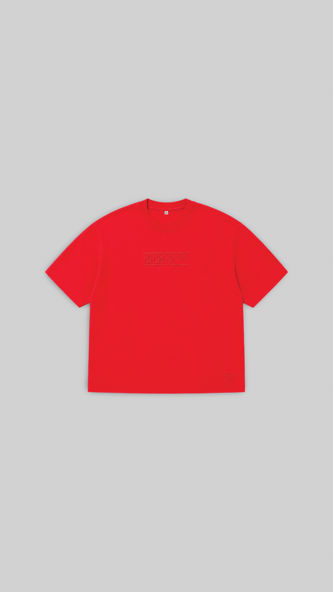 A bright red short-sleeve crewneck t-shirt with a subtle tonal dark red graphic across the chest, displayed flat against a solid light gray background.